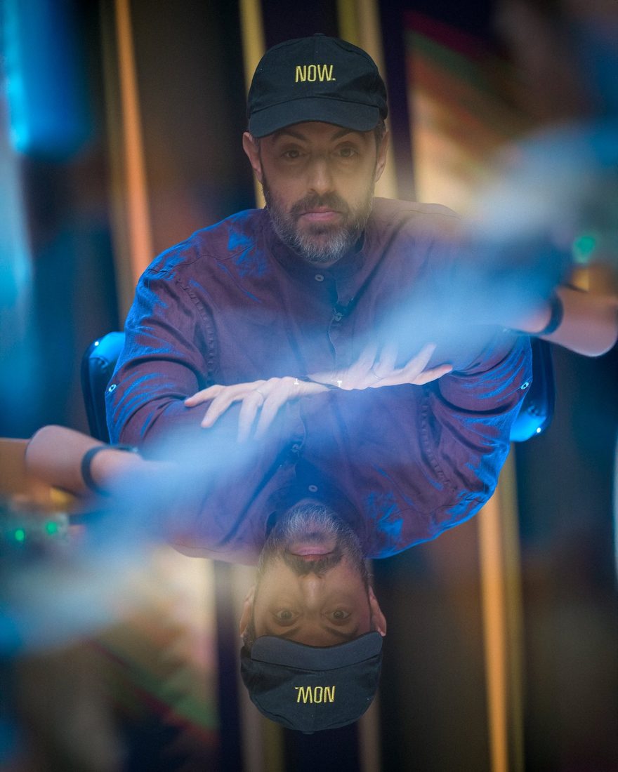 Mirrored table reflection portrait of a poker player, photographed by Drew Amato